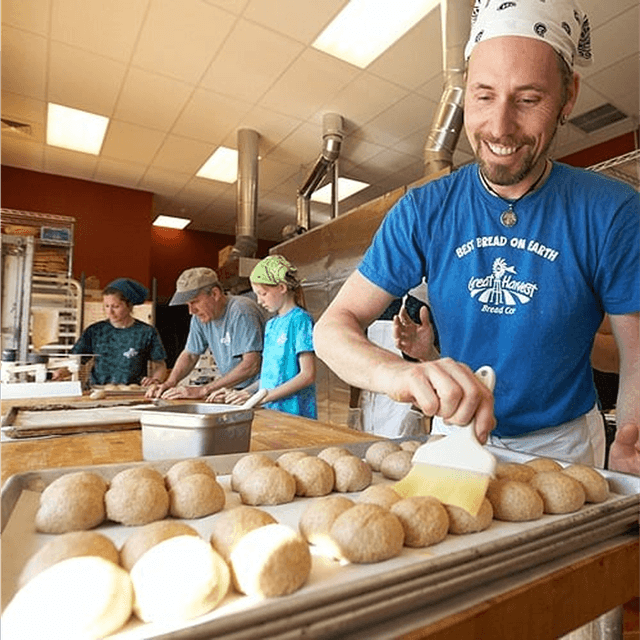 Image of a franchisee cheerfully buttering a loaf of bread